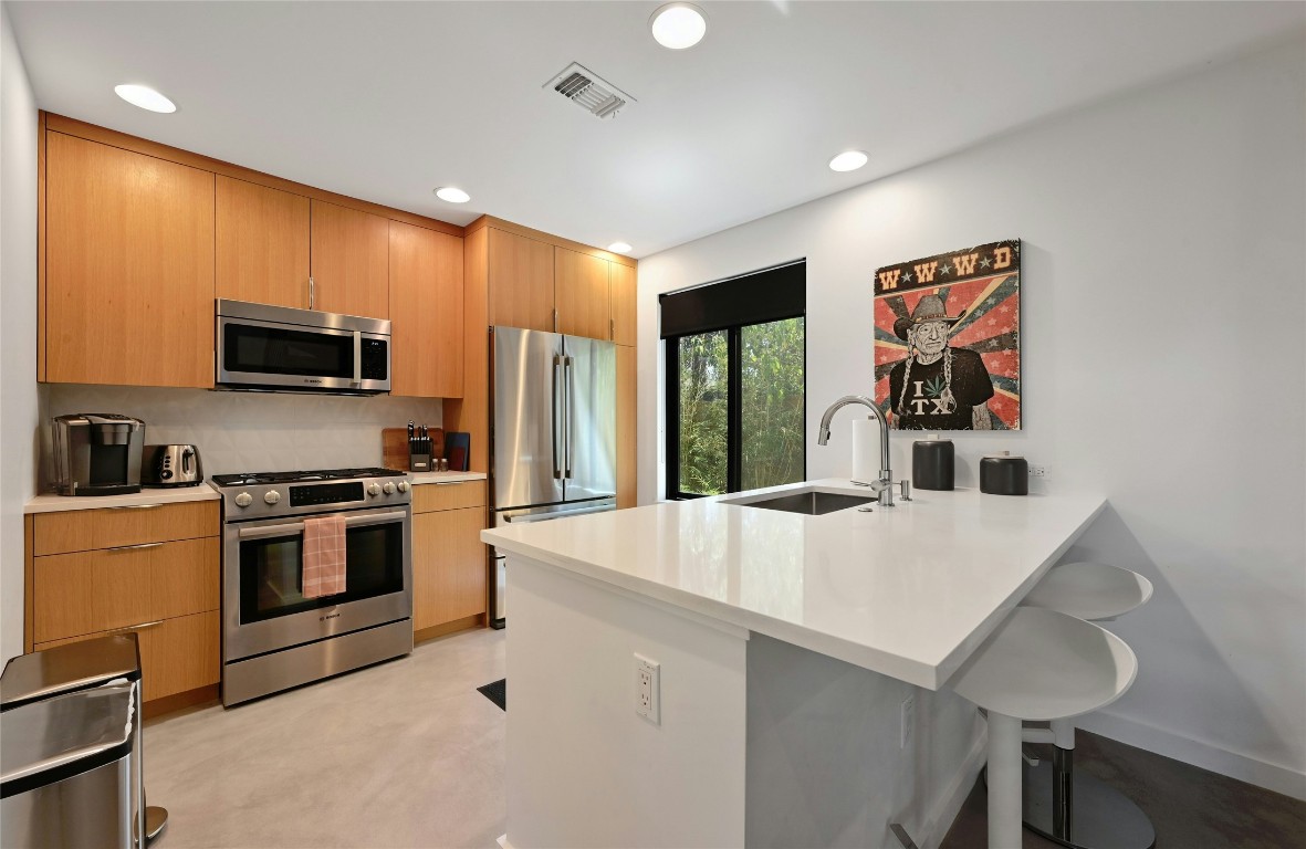 407 South Park Drive, Unit 2 Austin, TX 78704 - Photo 12 of 25 a kitchen with stainless steel appliances a stove refrigerator sink and microwave
