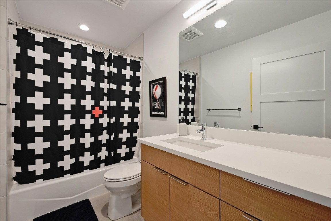 407 South Park Drive, Unit 2 Austin, TX 78704 - Photo 16 of 25 a bathroom with a sink a toilet and shower curtain