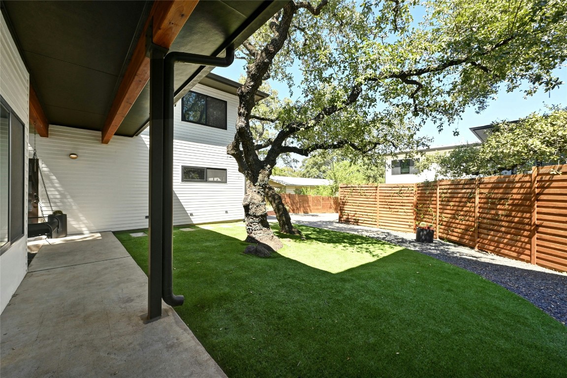 407 South Park Drive, Unit 2 Austin, TX 78704 - Photo 4 of 25 a view of a backyard with wooden fence and a bench