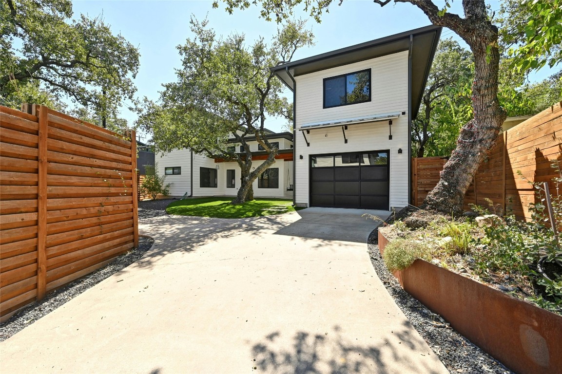 407 South Park Drive, Unit 2 Austin, TX 78704 - Photo 5 of 25 a front view of a house with a yard and garage
