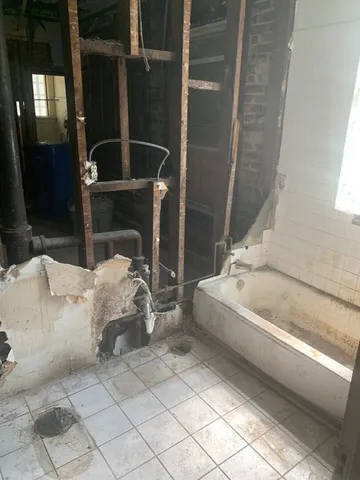 a bathroom with a bathtub and shower