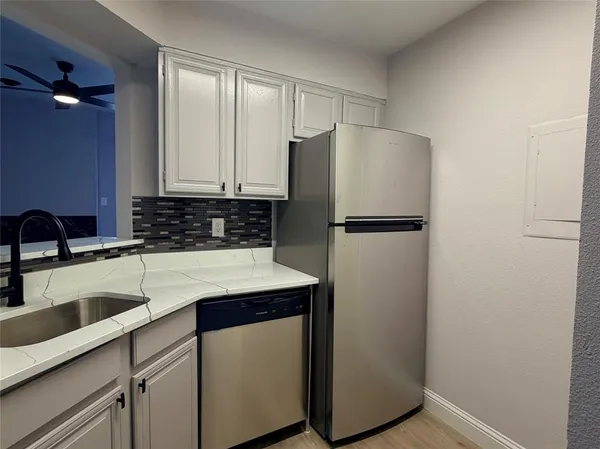a kitchen with a refrigerator and a sink