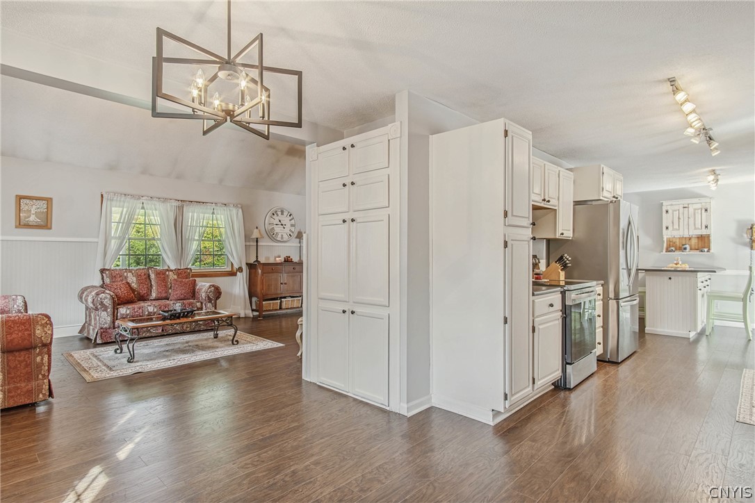 15384 Fuller Road Adams, NY 13606 - Photo 29 of 50 Gleaming hardwood floors and a spacious open layout seamlessly connect the kitchen and living areas.