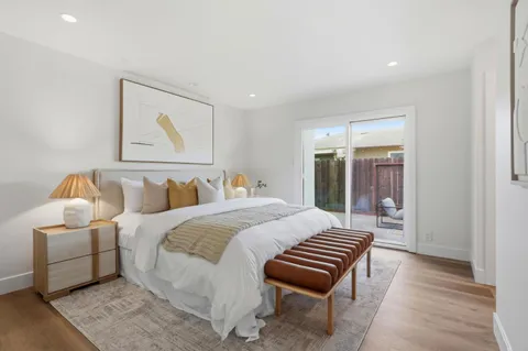 a spacious bedroom with a bed and a couch