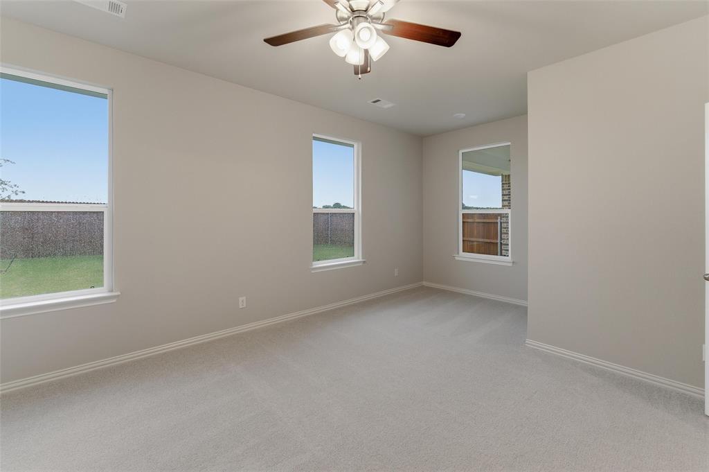 1329 Frio Drive Springtown, TX 76082 - Photo 16 of 25 Spacious room featuring neutral carpeting and light-toned walls