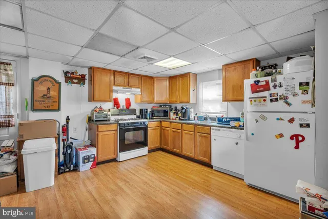 a kitchen with granite countertop stainless steel appliances and wooden cabinets