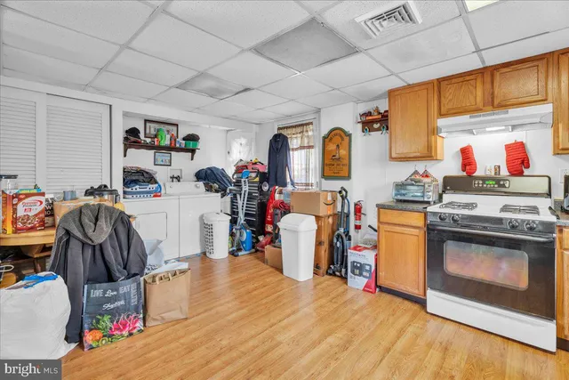 a view of a kitchen with fridge and workspace