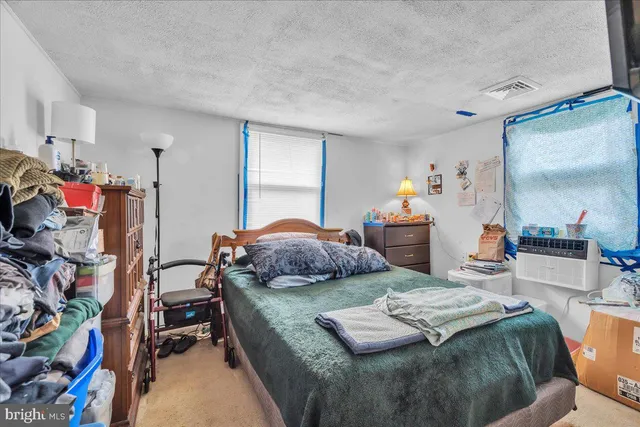 a bedroom with furniture and a wooden floor