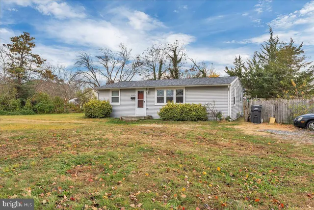a front view of a house with a garden and yard