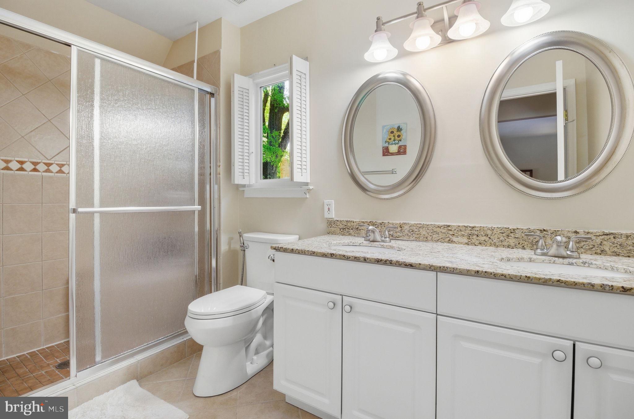 1509 Farsta Court Reston, VA 20190 - Photo 28 of 40 a bathroom with a granite countertop toilet sink and mirror