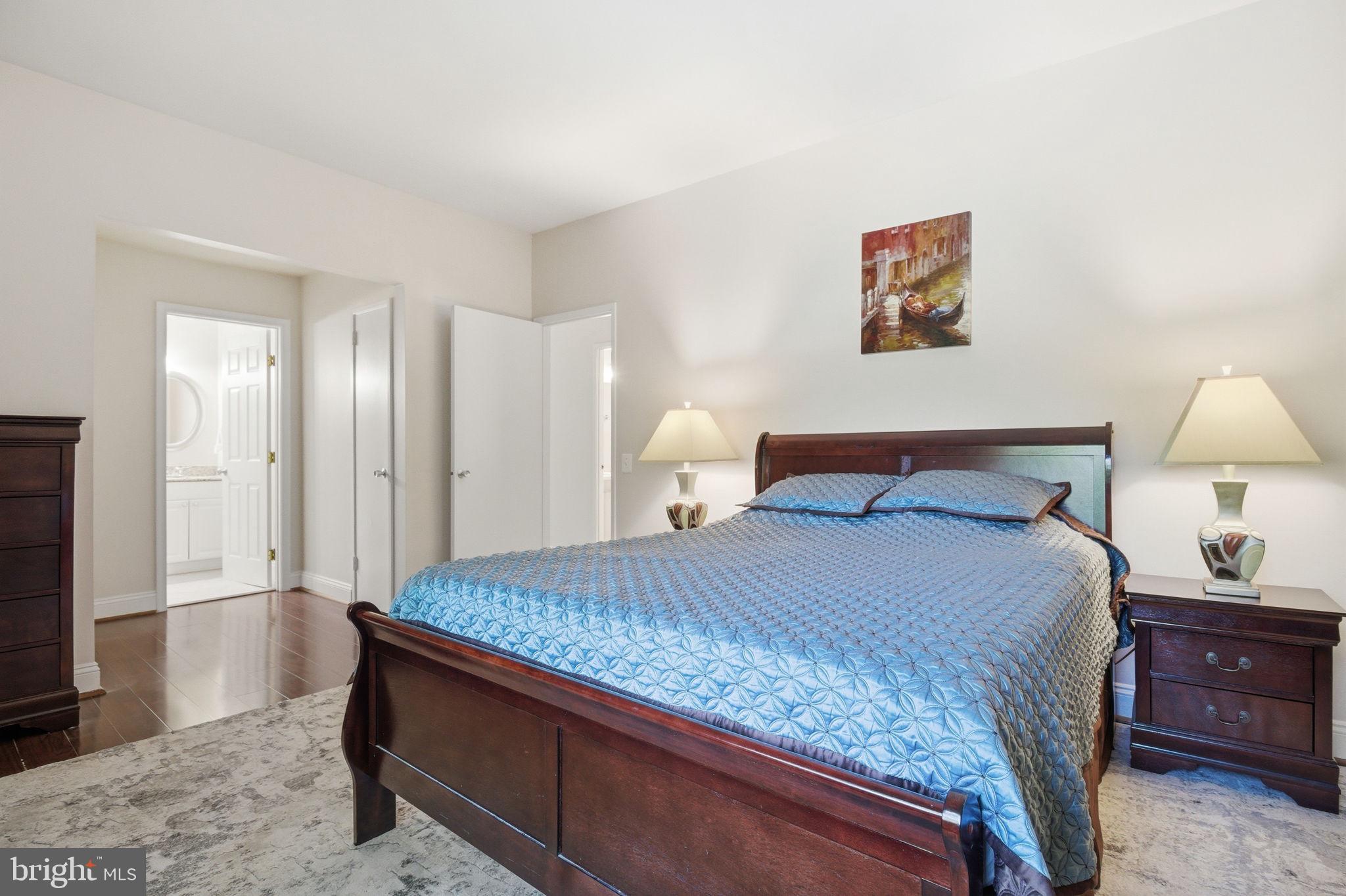 1509 Farsta Court Reston, VA 20190 - Photo 29 of 40 a bedroom with a bed and a lamp on table