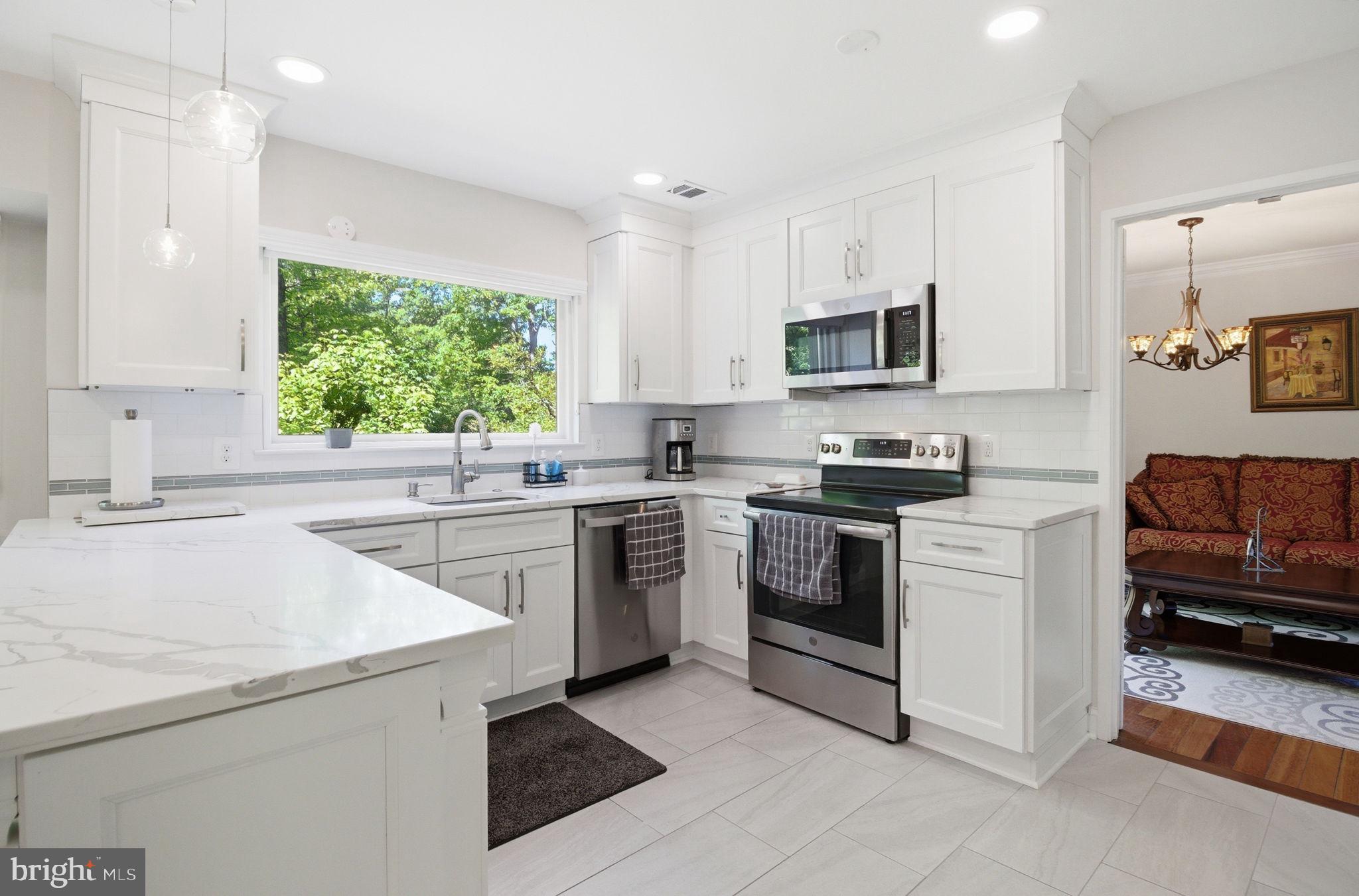 1509 Farsta Court Reston, VA 20190 - Photo 4 of 40 a kitchen with a sink stove and microwave