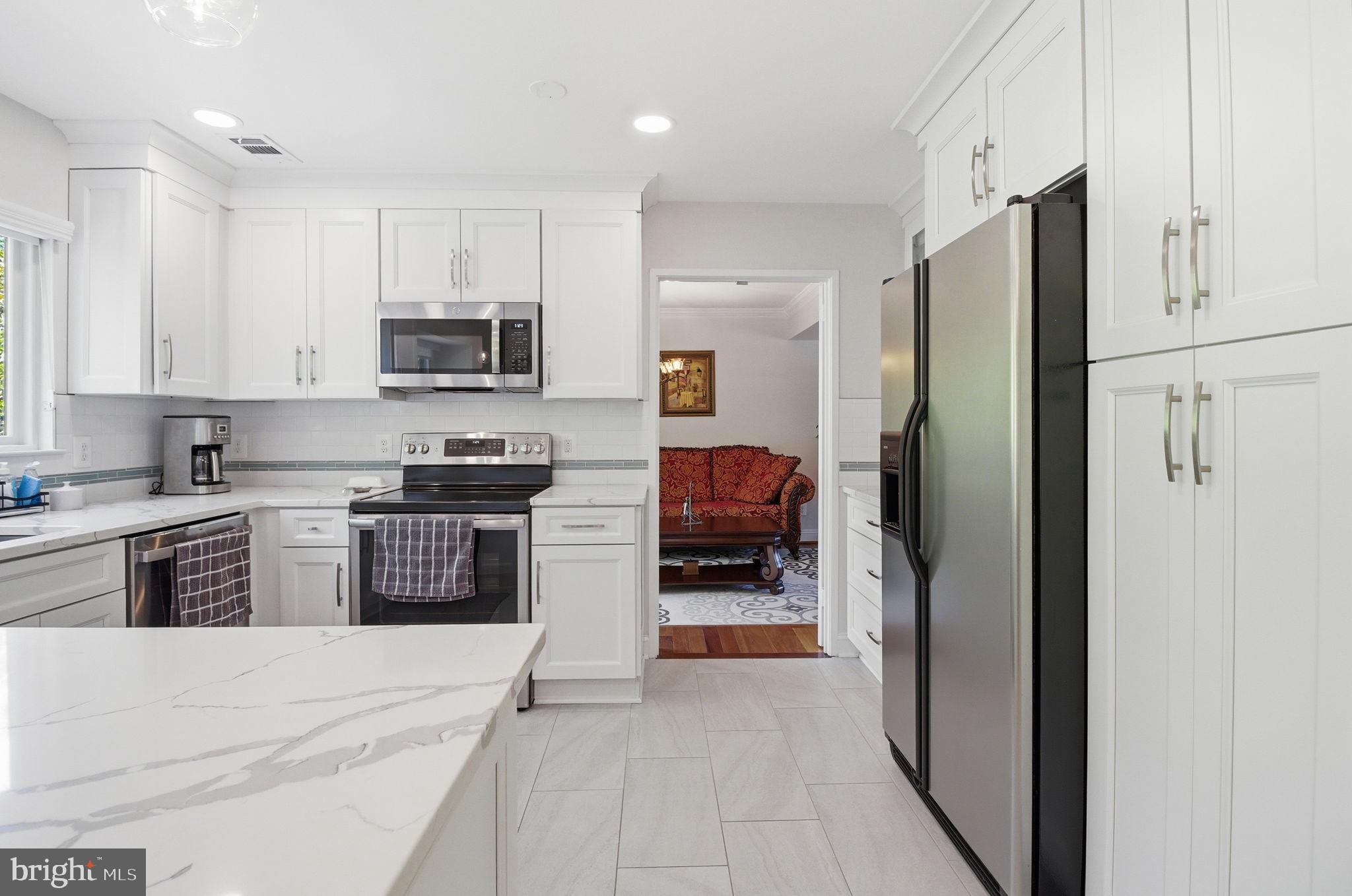 1509 Farsta Court Reston, VA 20190 - Photo 6 of 40 a kitchen with stainless steel appliances granite countertop a refrigerator sink and stove