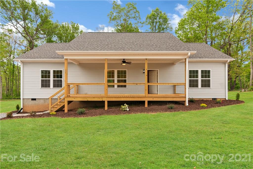 296 Ridge View Drive, Unit 7 Clyde, NC 28721 - Photo 2 of 19 a view of a house with a yard and sitting area