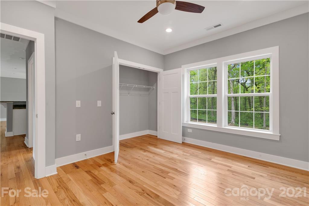 296 Ridge View Drive, Unit 7 Clyde, NC 28721 - Photo 17 of 19 an empty room with wooden floor and windows