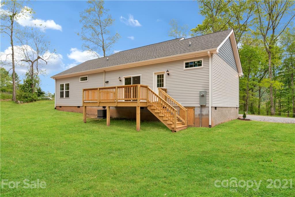 296 Ridge View Drive, Unit 7 Clyde, NC 28721 - Photo 19 of 19 a view of a house with a yard