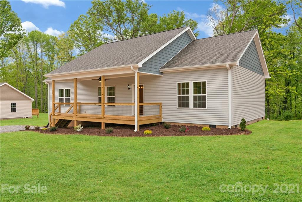 296 Ridge View Drive, Unit 7 Clyde, NC 28721 - Photo 3 of 19 a view of a house with a yard