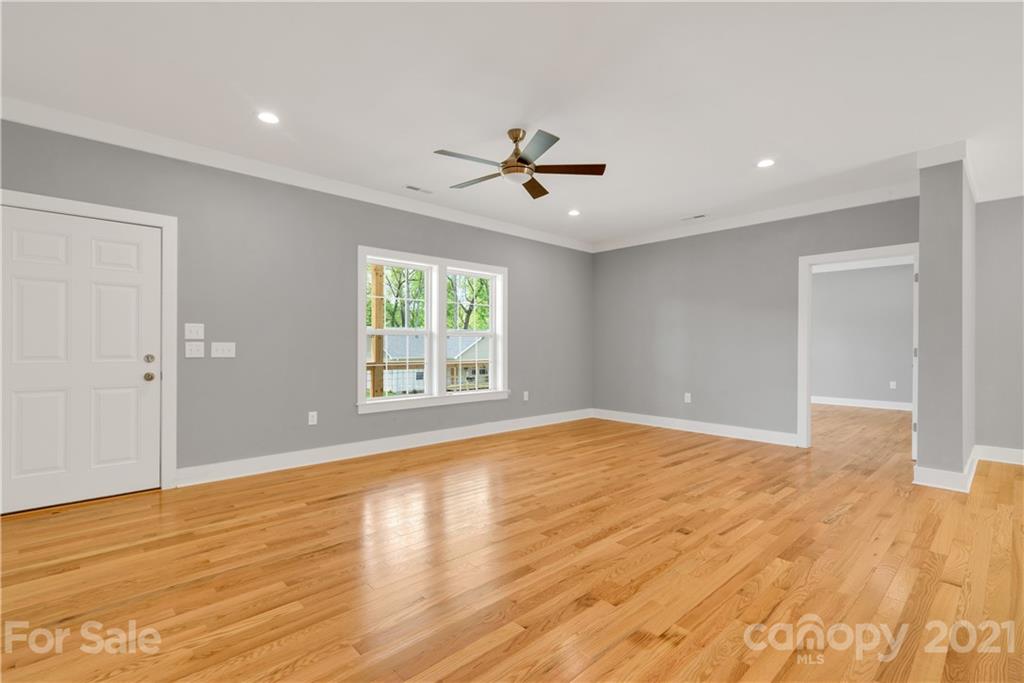 296 Ridge View Drive, Unit 7 Clyde, NC 28721 - Photo 5 of 19 a view of empty room with wooden floor and fan
