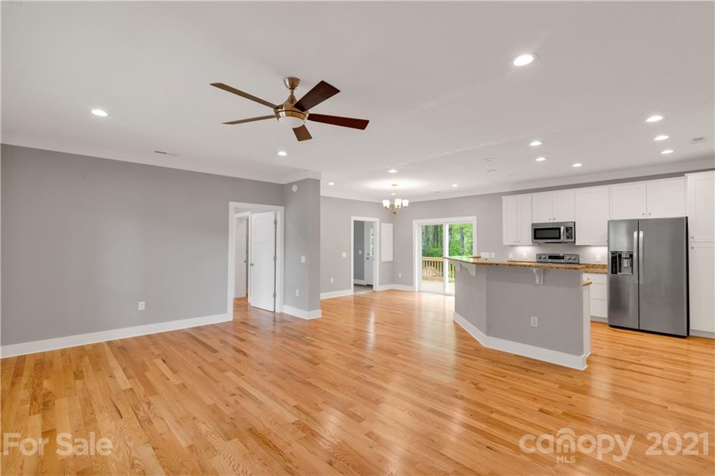 296 Ridge View Drive, Unit 7 Clyde, NC 28721 - Photo 7 of 19 a view of empty room with wooden floor and window