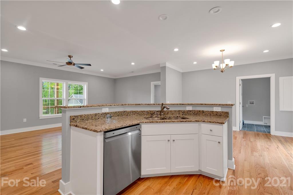296 Ridge View Drive, Unit 7 Clyde, NC 28721 - Photo 10 of 19 a kitchen with granite countertop a sink window and cabinets