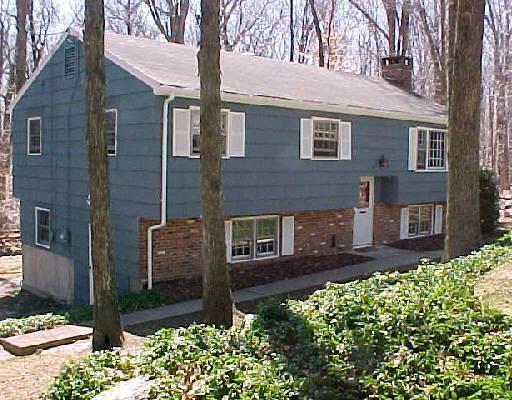38 Forest Drive Ridgefield, CT 06877 - Photo 1 of 1 a view of a brick house with a yard potted plants and large tree