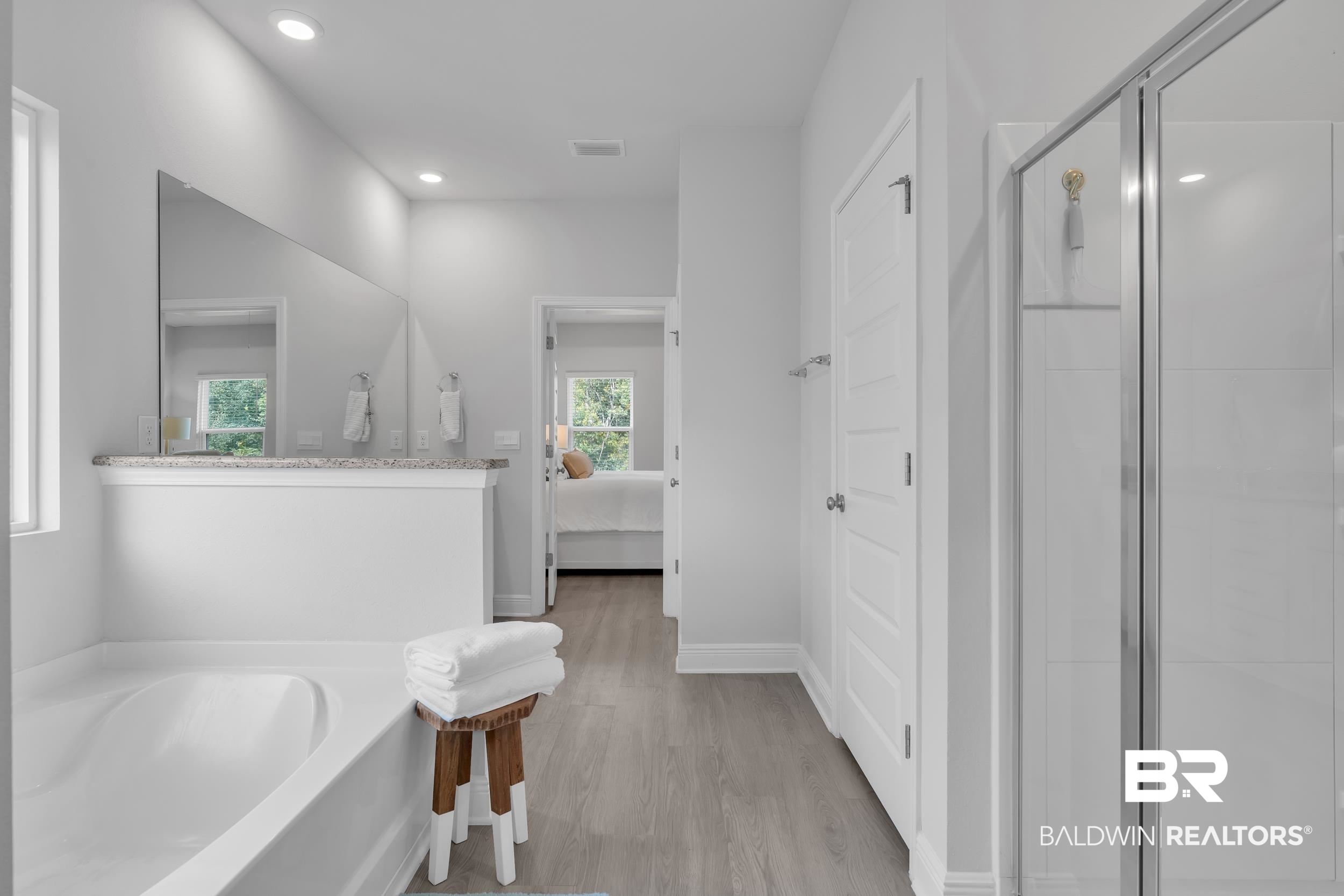 8774 Primland Boulevard Foley, AL 36535 - Photo 21 of 49 Ensuite bathroom featuring a stall shower, light wood-style flooring, a garden tub, and recessed lighting