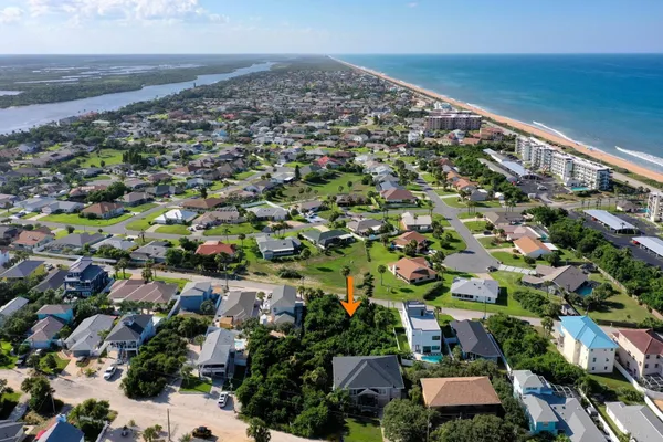 an aerial view of a houses with a yard
