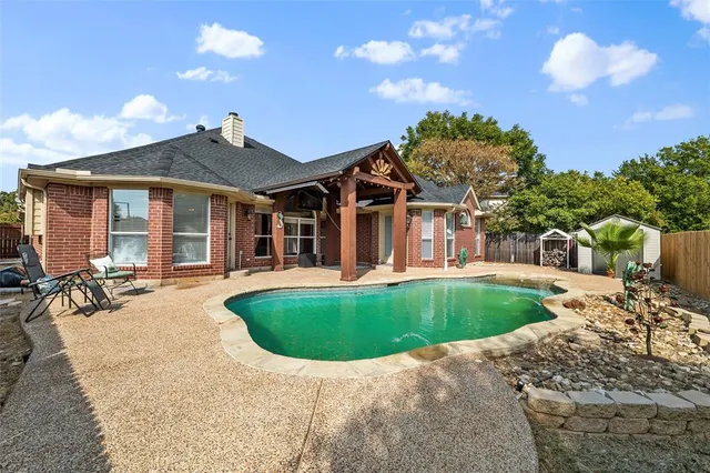 a view of a house with backyard porch and sitting area