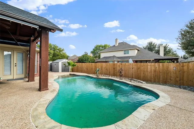 a view of a backyard with swimming pool