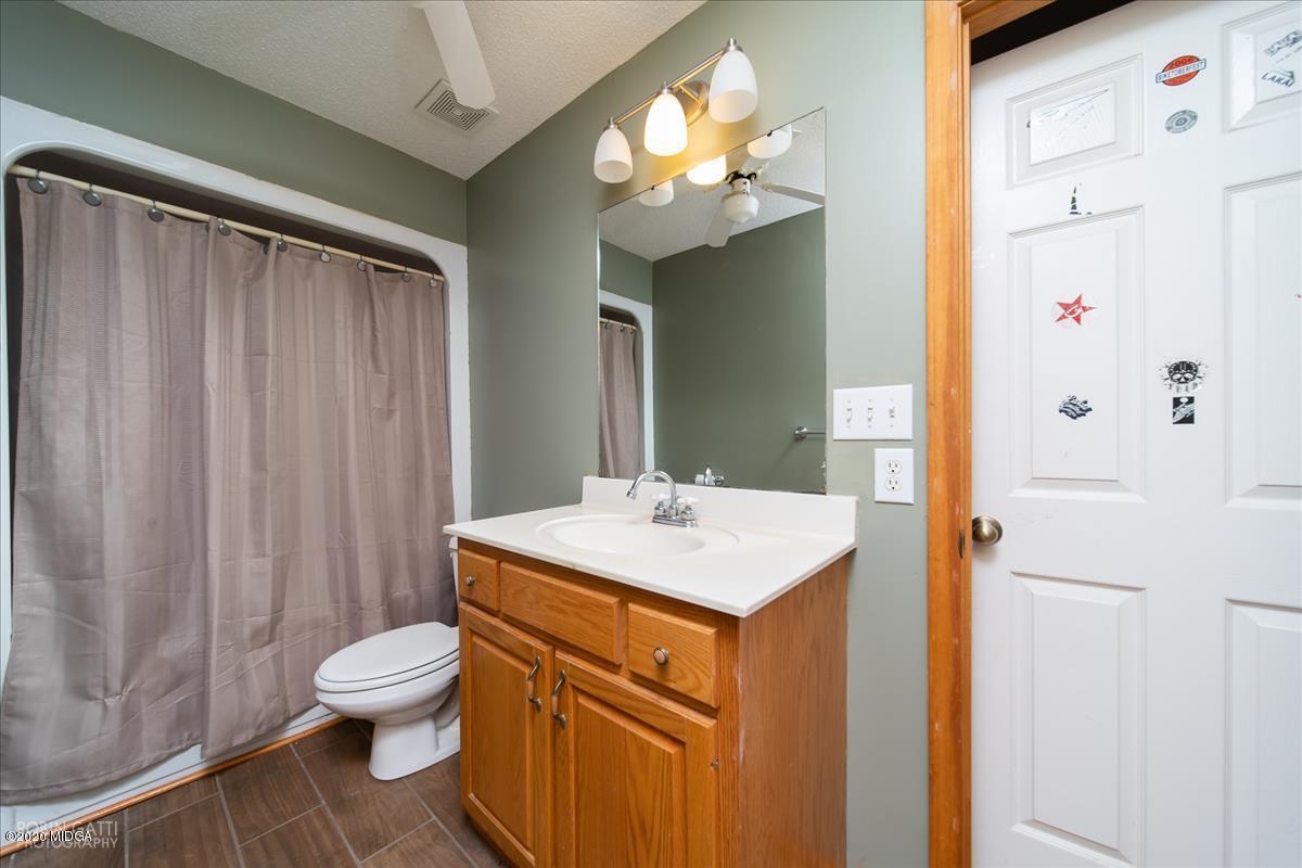 146 Old Graham Road Gray, GA 31032 - Photo 15 of 33 a bathroom with a sink a toilet and a mirror