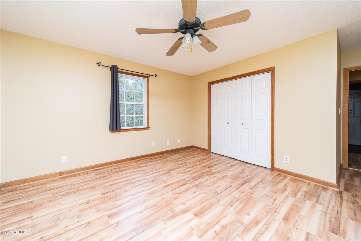 146 Old Graham Road Gray, GA 31032 - Photo 16 of 33 a view of empty room with wooden floor and fan