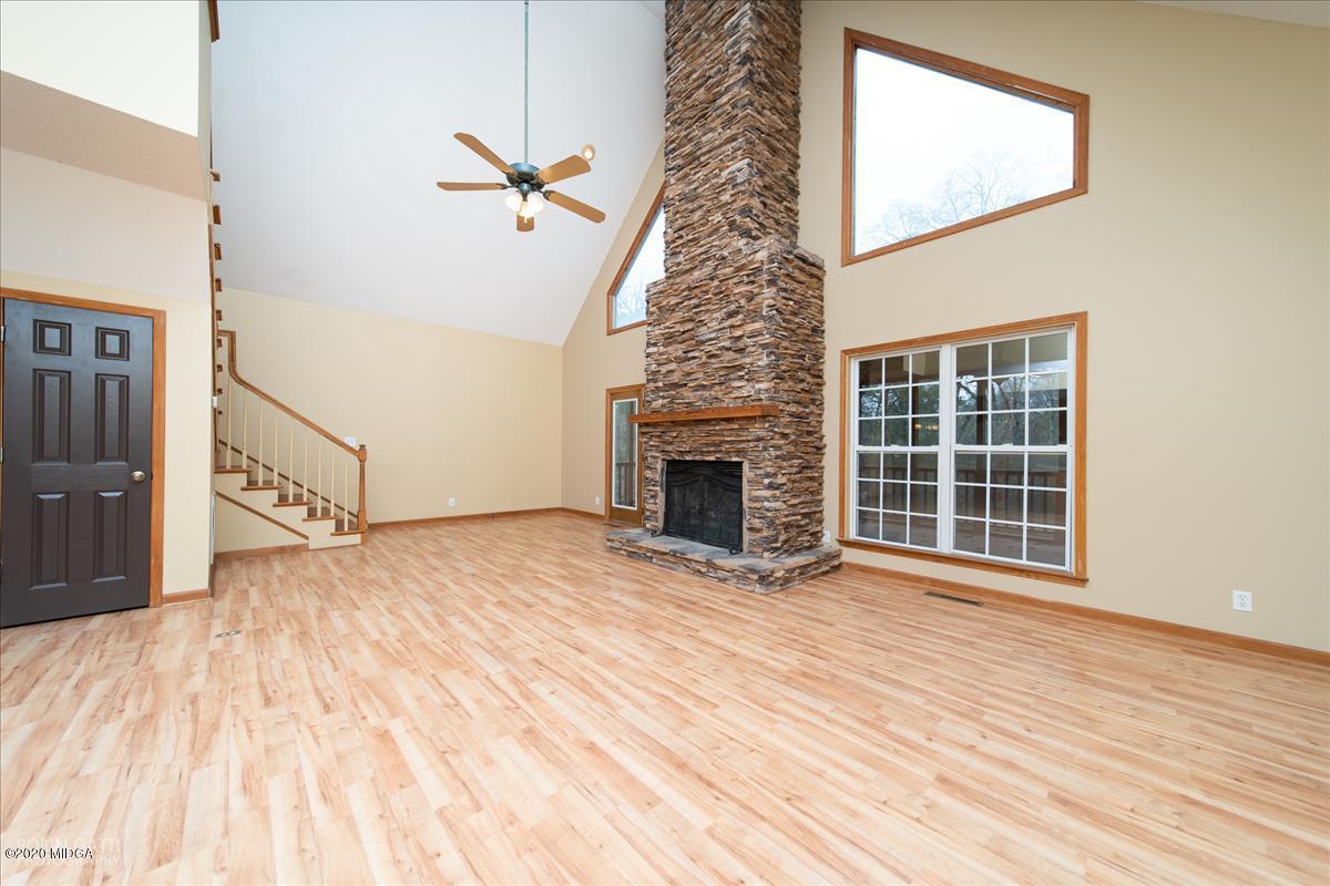146 Old Graham Road Gray, GA 31032 - Photo 5 of 33 a view of empty room with wooden floor and fireplace
