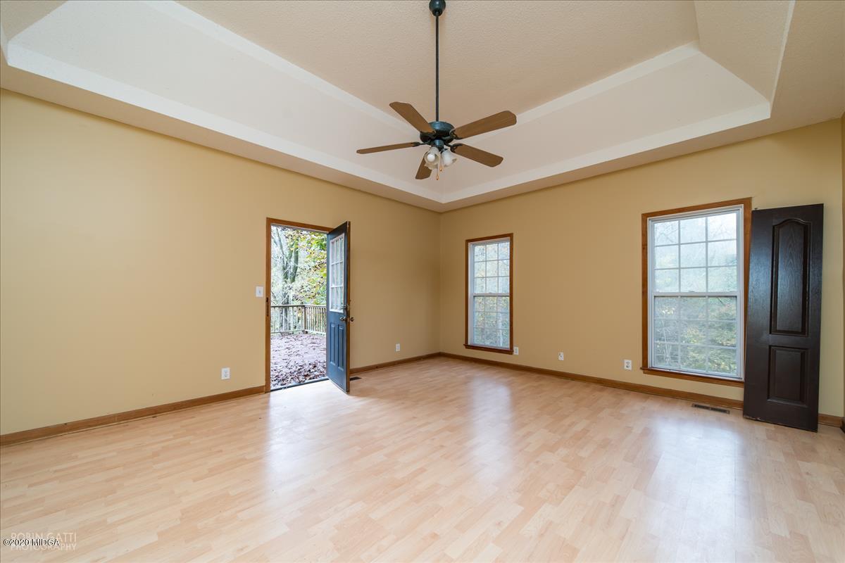 146 Old Graham Road Gray, GA 31032 - Photo 10 of 33 a view of an empty room with a window and a ceiling fan