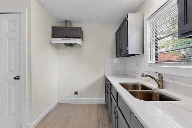 a kitchen with a sink a microwave and window