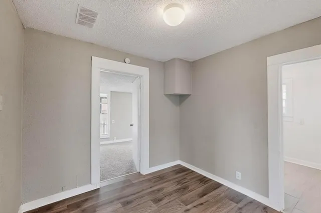 a view of an empty room and wooden floor
