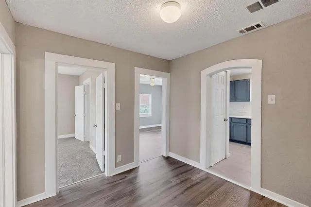 a view of a hallway with wooden floor