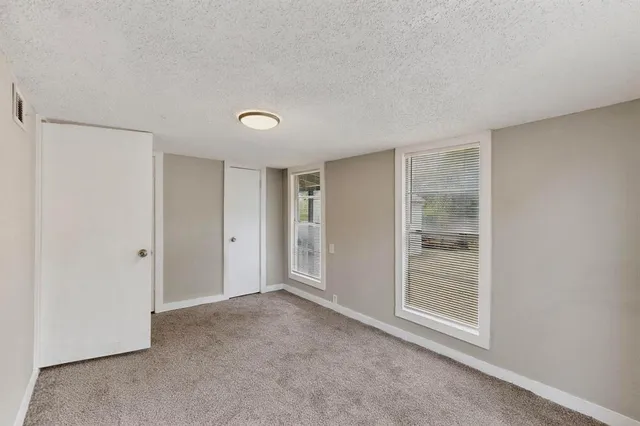 a view of an empty room with closet area