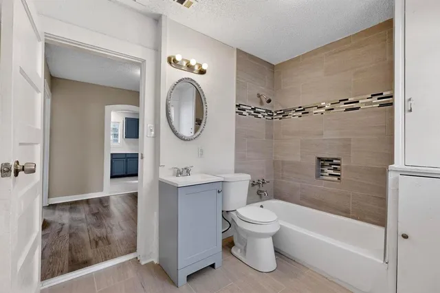 a bathroom with a toilet a sink and bathtub