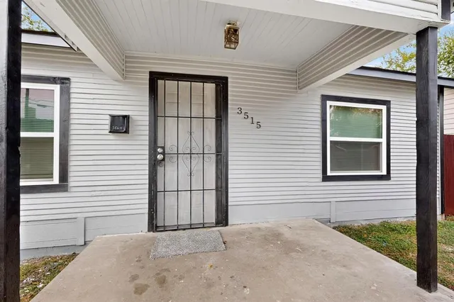 a view of a house with wooden fence