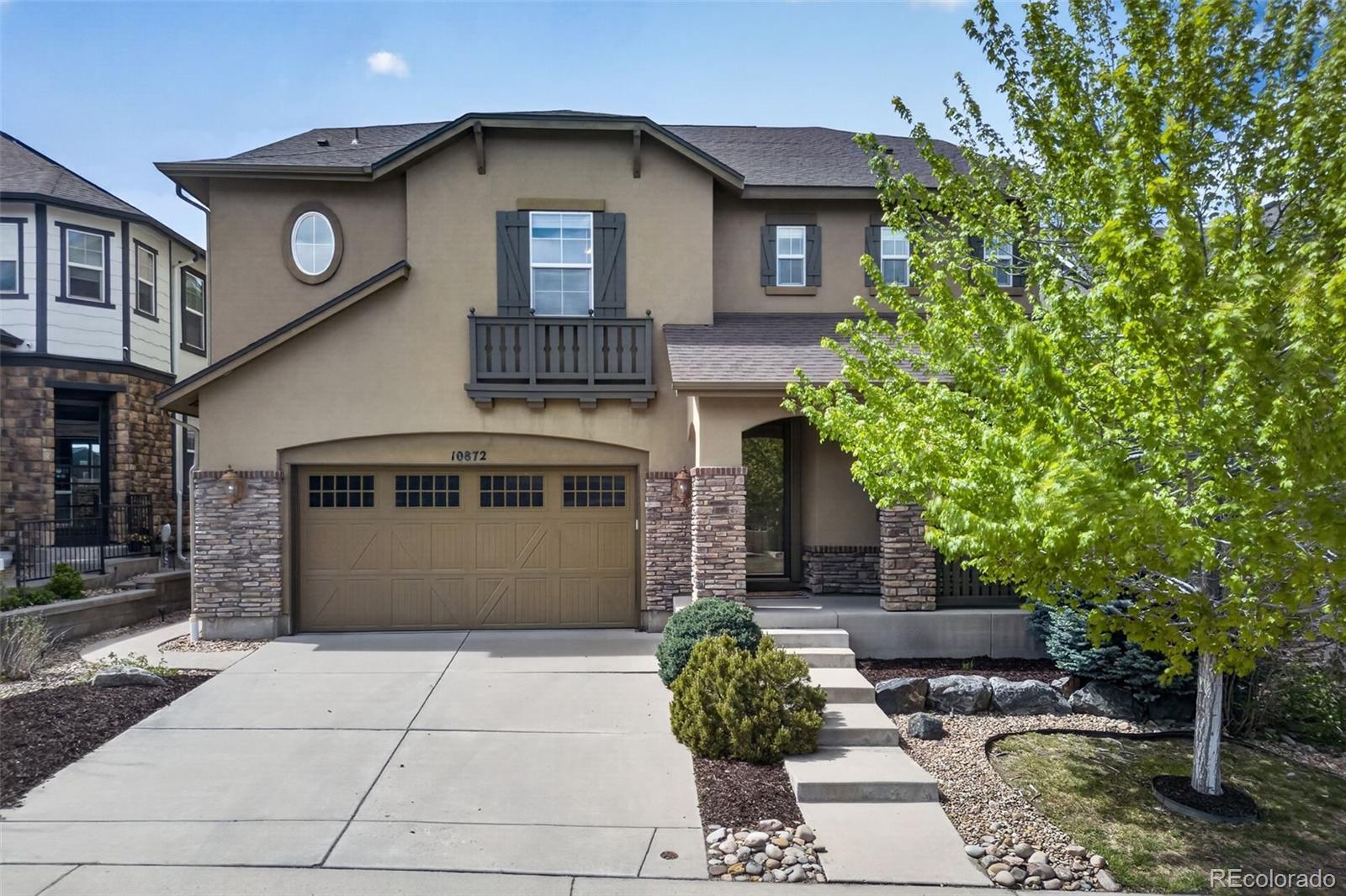 10872 Valleybrook Circle Highlands Ranch, CO 80130 - Photo 1 of 50 a front view of a house with garden