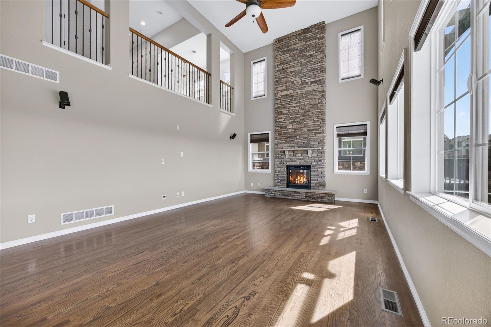 10872 Valleybrook Circle Highlands Ranch, CO 80130 - Photo 18 of 50 a view of a livingroom with wooden floor and a fireplace