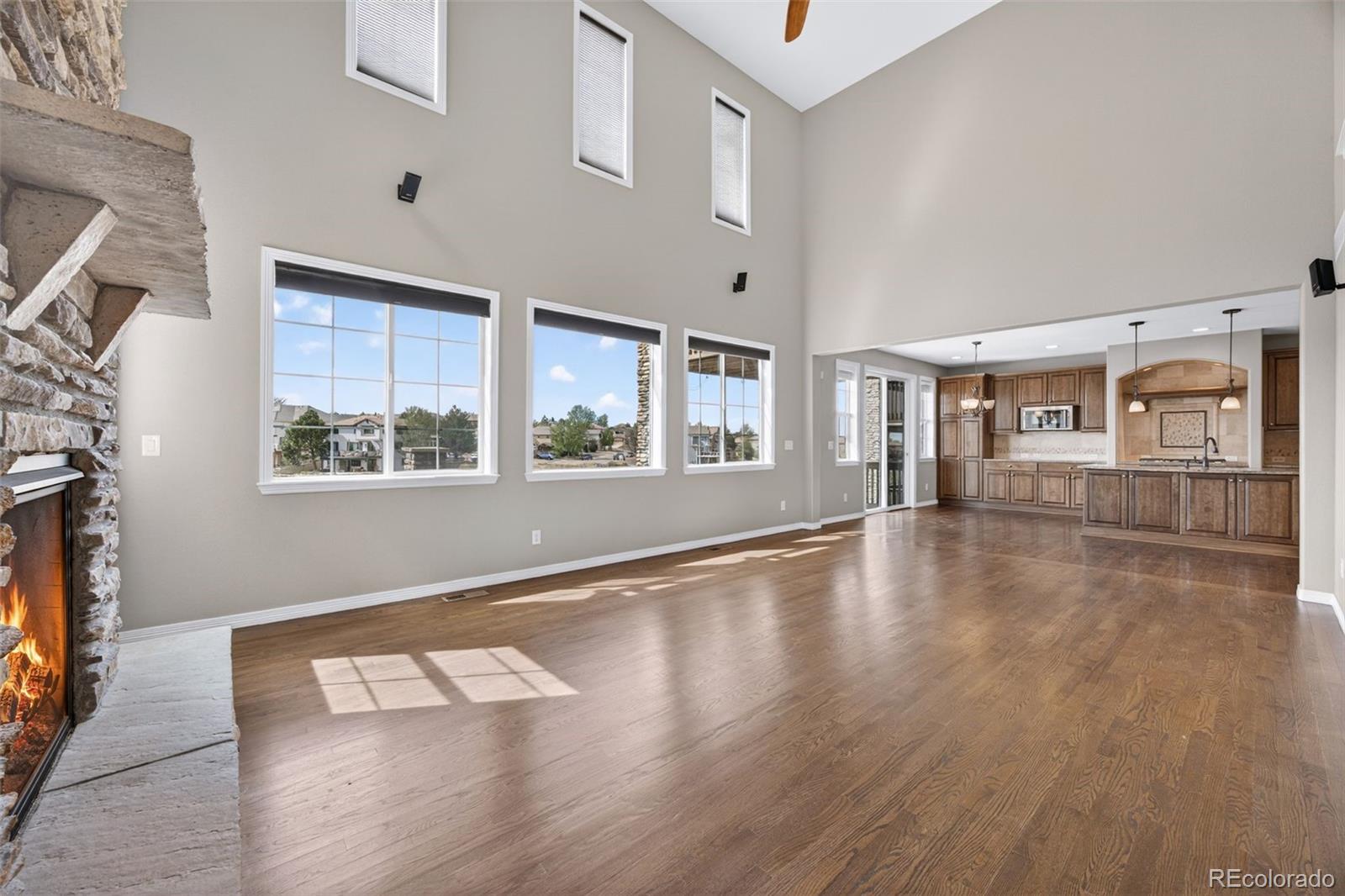 10872 Valleybrook Circle Highlands Ranch, CO 80130 - Photo 21 of 50 a view of an empty room with wooden floor and a window