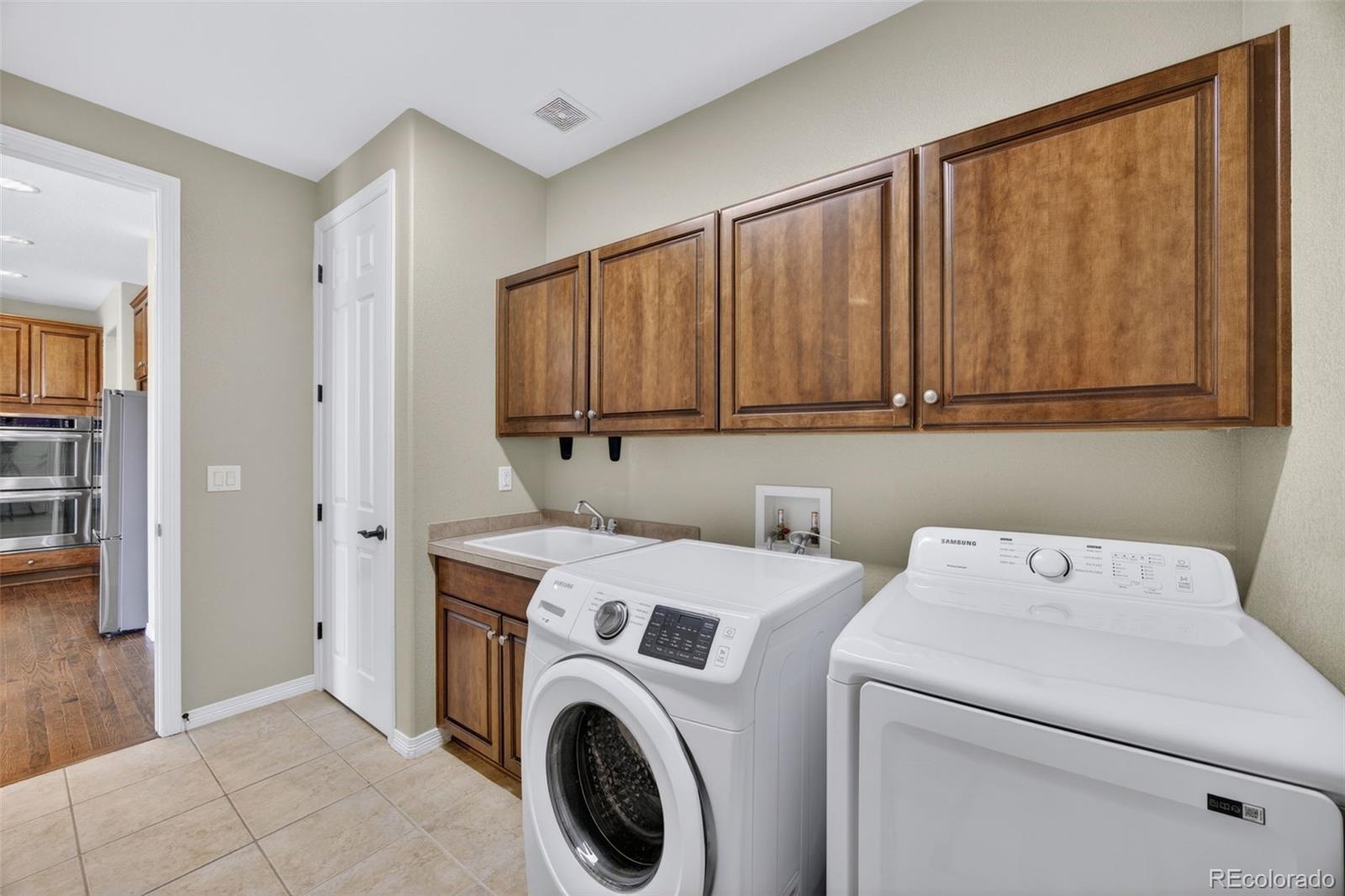 10872 Valleybrook Circle Highlands Ranch, CO 80130 - Photo 22 of 50 a utility room with dryer and washer