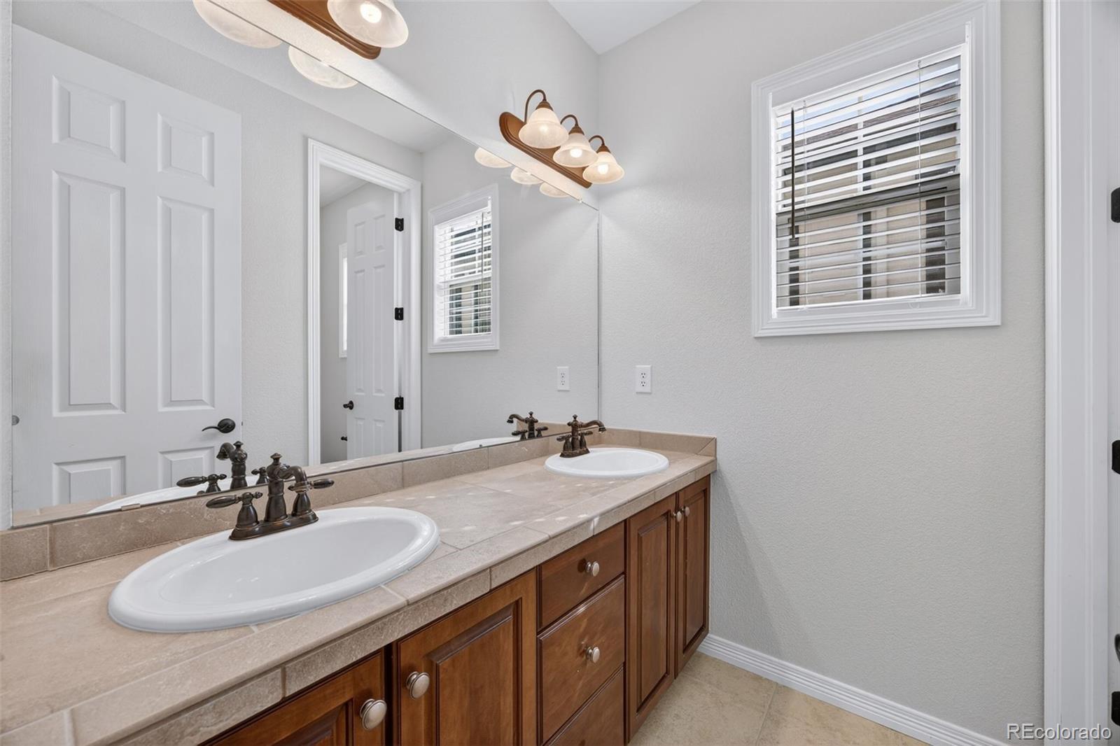 10872 Valleybrook Circle Highlands Ranch, CO 80130 - Photo 25 of 50 a bathroom with a sink and a mirror