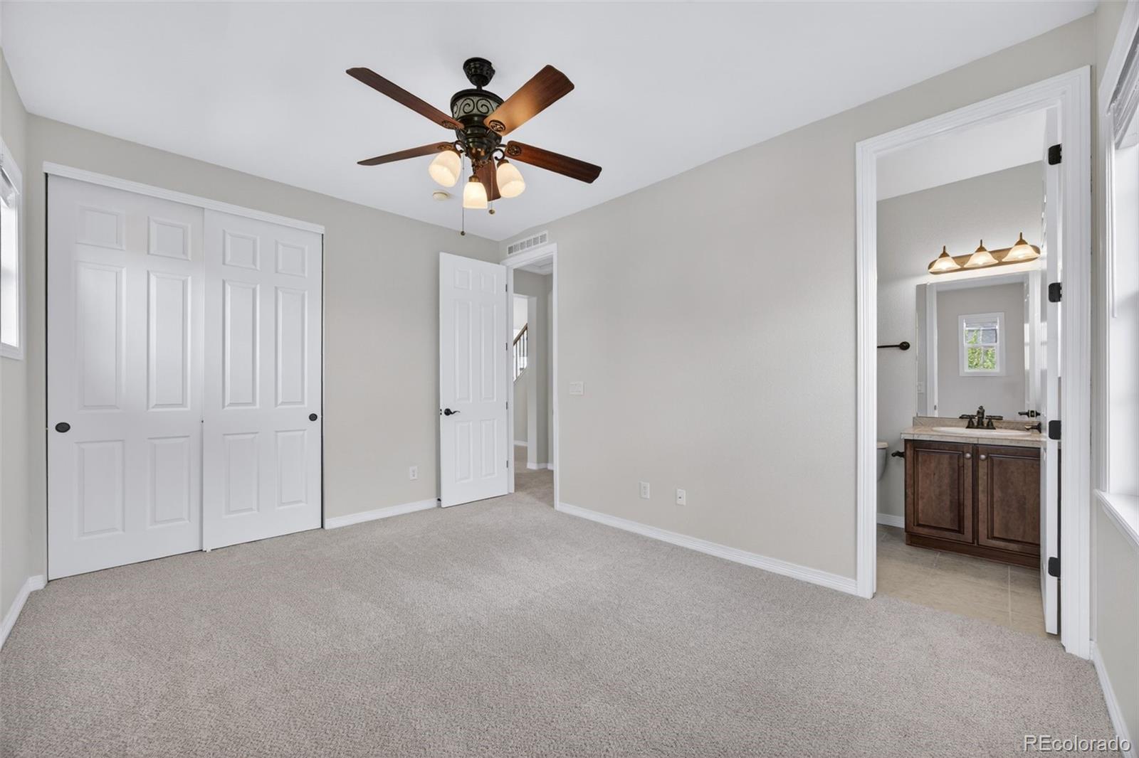 10872 Valleybrook Circle Highlands Ranch, CO 80130 - Photo 31 of 50 a view of a livingroom with a chandelier fan and windows