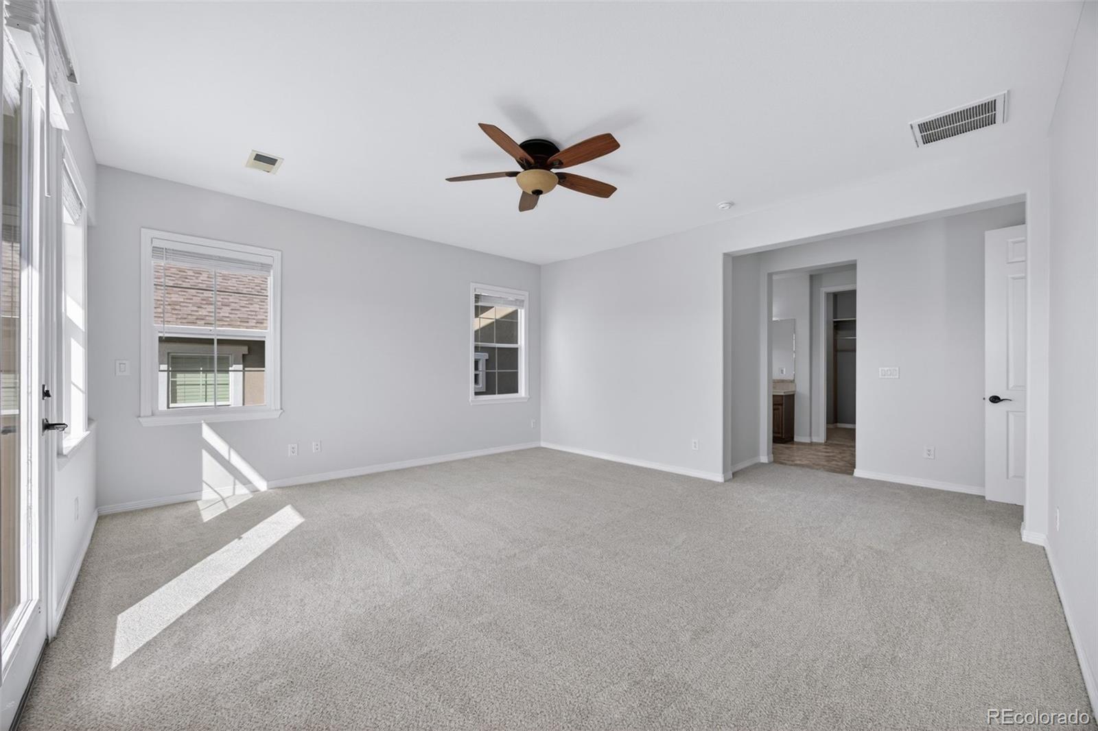 10872 Valleybrook Circle Highlands Ranch, CO 80130 - Photo 36 of 50 a view of a livingroom with a ceiling fan and window