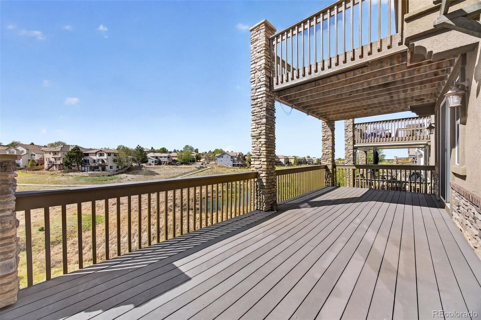 10872 Valleybrook Circle Highlands Ranch, CO 80130 - Photo 45 of 50 a view of balcony with wooden floor and outdoor seating