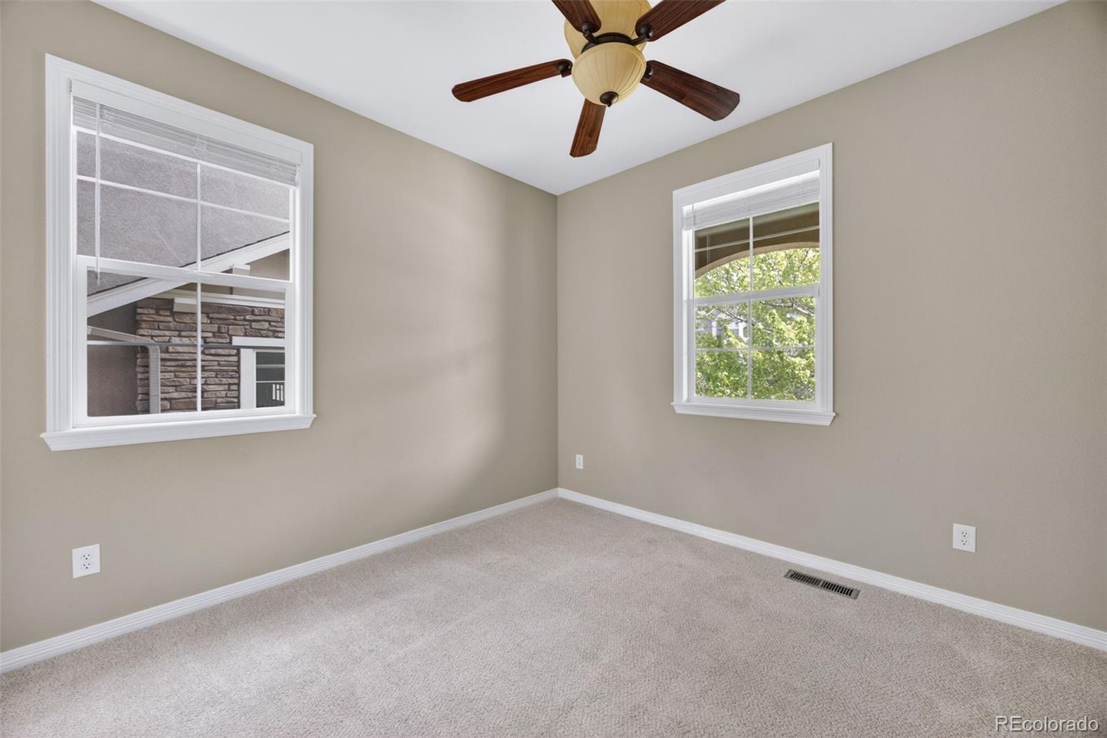 10872 Valleybrook Circle Highlands Ranch, CO 80130 - Photo 6 of 50 an empty room with windows and fan