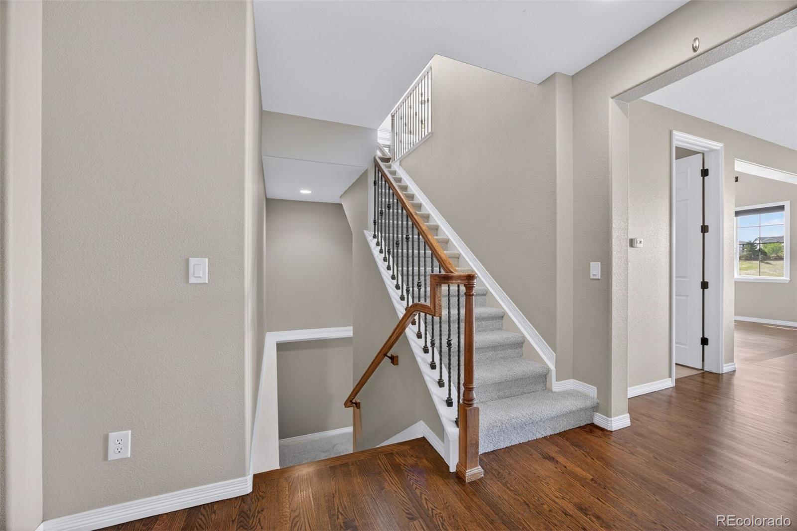 10872 Valleybrook Circle Highlands Ranch, CO 80130 - Photo 8 of 50 a view of a hallway with wooden floor and entryway