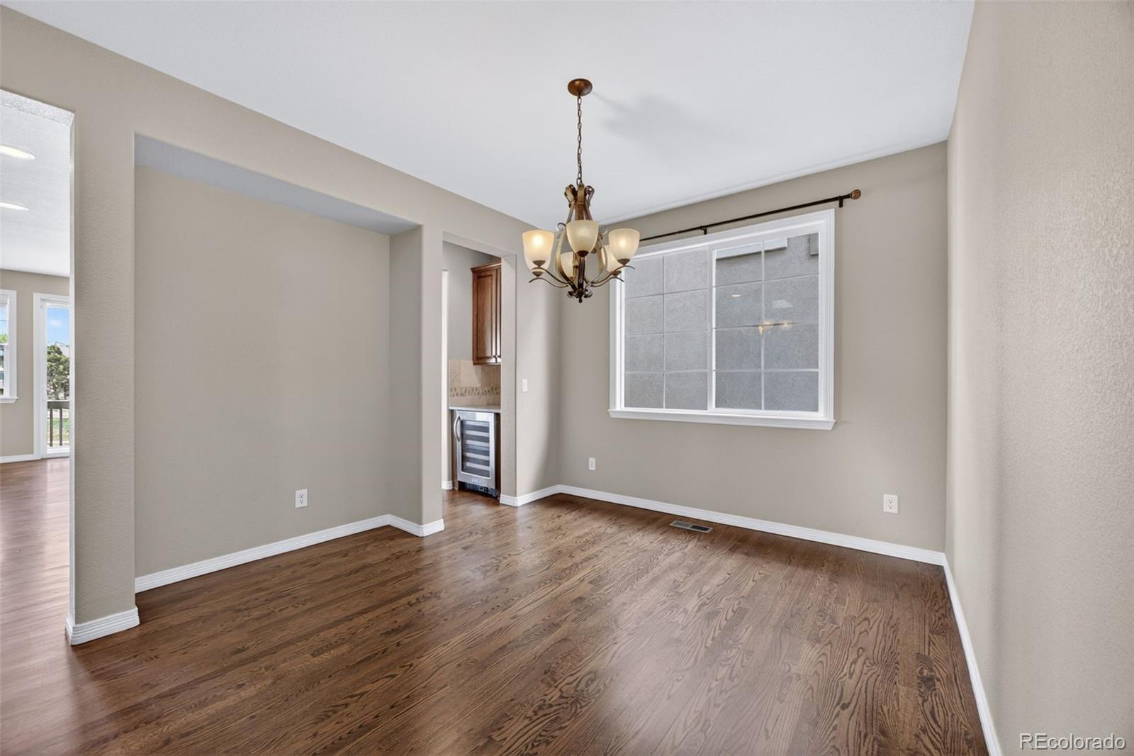 10872 Valleybrook Circle Highlands Ranch, CO 80130 - Photo 9 of 50 a view of a room with window wooden floor and chandelier